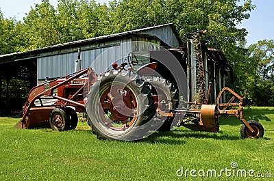 Farmall M tractor, front end loader, and lawn mower Editorial Stock Photo