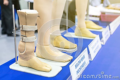 Farmer and below knee prosthesis leg or elbow knee with other type for disabled for walk on stand and place on blue table Stock Photo