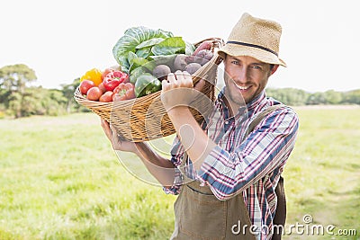 Farmer carrying basket of veg Stock Photo