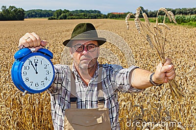 Farmer with Clock 11:55 Stock Photo