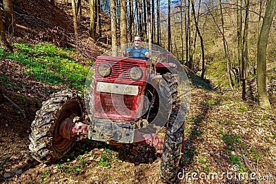 Farmer driving a old tractor Stock Photo