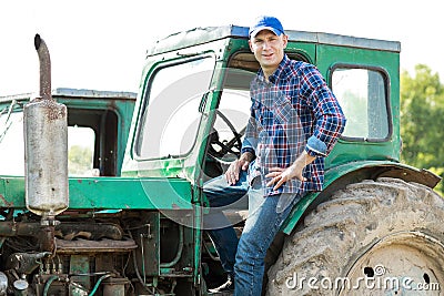 Farmer driving tractor in countryside Stock Photo