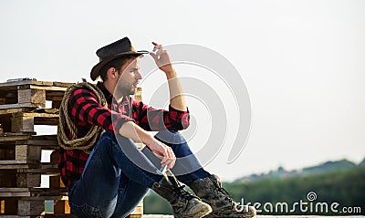 Farmer enjoy view from his farm. Peaceful mood. Watching sunset. Farmer cowboy handsome man relaxing after hard working Stock Photo
