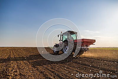 Farmer fertilizing arable land Stock Photo