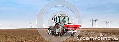 Farmer fertilizing arable land with nitrogen, phosphorus, potassium fertilizer. Stock Photo