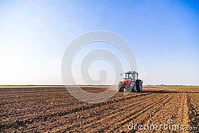 Farmer fertilizing arable land with nitrogen, phosphorus, potassium fertilizer Stock Photo