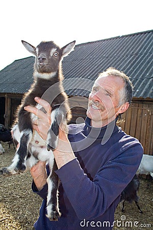 The farmer with goatling. Stock Photo