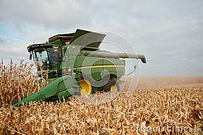 Farmer harvesting maize with a combine harvester Stock Photo