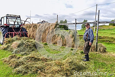 Farmer and hayrack, traditional haymaking nordic style in Finnish Lapland Editorial Stock Photo