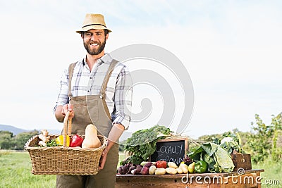 Farmer holding basket of vegetables at market Stock Photo