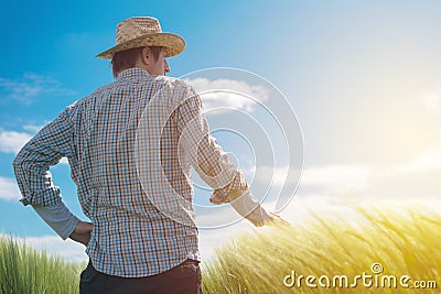 Farmer looking at the sun on the horizon Stock Photo