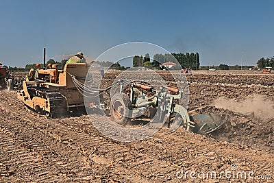 Farmer plowing the field with an old crawler tractor Fiat Editorial Stock Photo