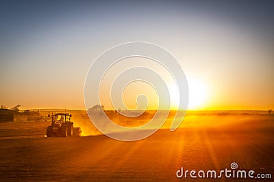 Farmer preparing his field in a tractor ready for spring Stock Photo