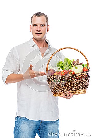 Farmer presents organic vegetables in a basket on a white Stock Photo