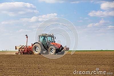 Farmer seeding, sowing crops at field. Stock Photo