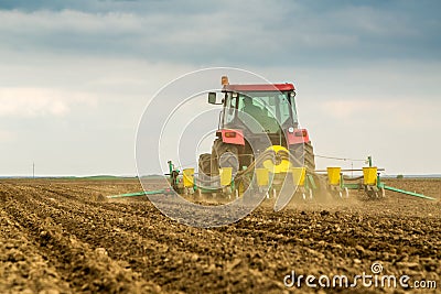 Farmer seeding, sowing crops at field. Stock Photo