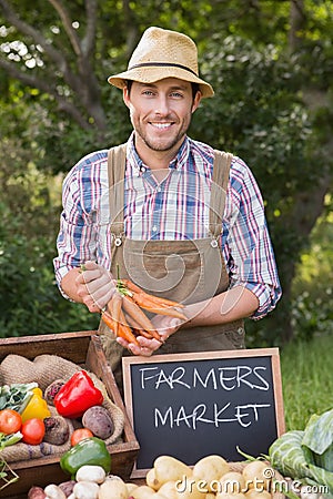 Farmer selling organic veg at market Stock Photo