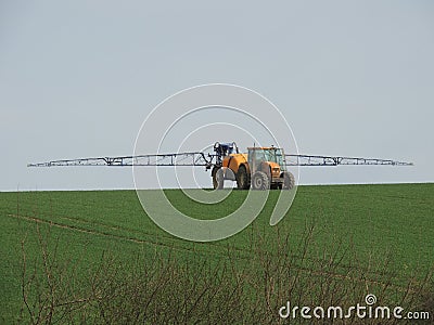 Farmer spraying chemicals in the fields Stock Photo