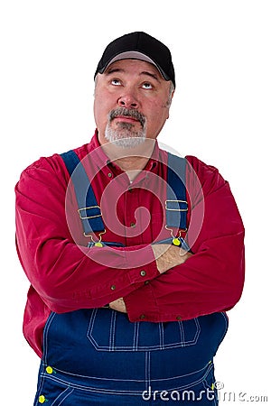 Farmer standing looking up deep in thought Stock Photo