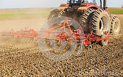 Farmer in tractor preparing land with seedbed cultivator Stock Photo