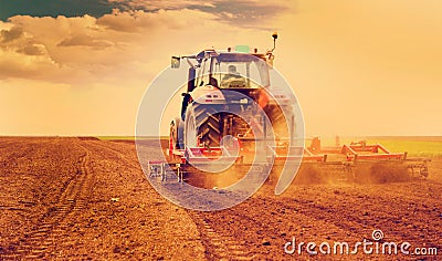 Farmer in tractor preparing land for sowing Stock Photo