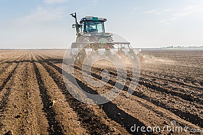 Farmer with tractor seeding - sowing soy crops at agricultural f Stock Photo