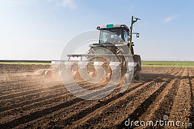 Farmer with tractor seeding - sowing soy crops at agricultural f Stock Photo