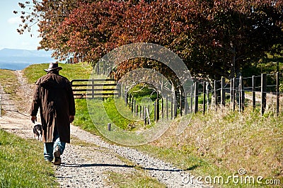 Farmer walking on his farm Stock Photo