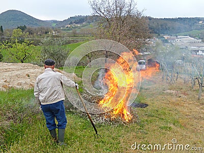 Farmer watching over a fire Editorial Stock Photo