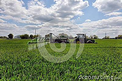 Farmer wheat field spraying herbicides Editorial Stock Photo