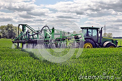 Farmer wheat field spraying herbicides Editorial Stock Photo