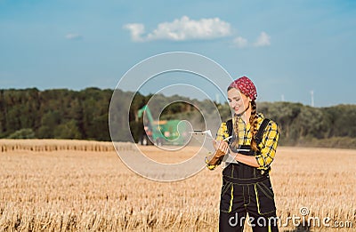 Farmer woman monitoring business progress of the harvest Stock Photo
