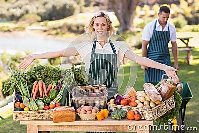 Farmer woman presenting a table of local food Stock Photo