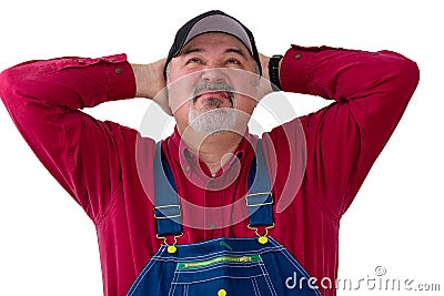 Farmer or worker in overalls looking up Stock Photo