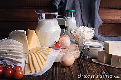 Farmers food products: milk, cream, cheese, eggs, cottage, butter. Rustic composition. Organic food concept Stock Photo