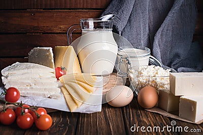 Farmers food products: milk, cream, cheese, eggs, cottage, butter. Rustic composition. Organic food concept Stock Photo