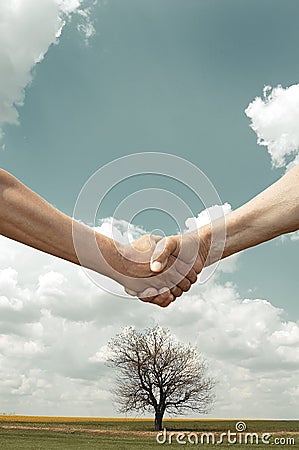 Farmers handshake with tree and field Stock Photo