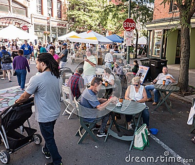 Farmers Market on a bright sunny day showing adults, children, dogs and vendors. Editorial Stock Photo