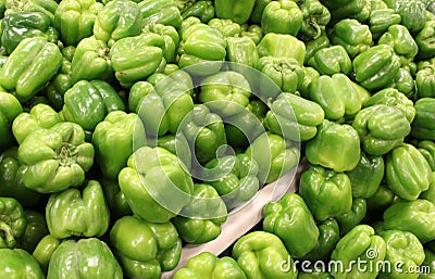 Farmers market table covered in fresh green peppers Stock Photo