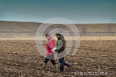 Farmers on plowed field Stock Photo