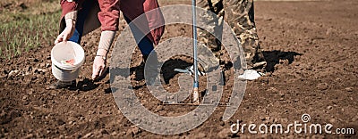 Farmers woman and man seeding plants Stock Photo