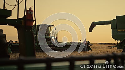 Farming machinery golden sunset field silhouette. Industrial equipment concept. Stock Photo