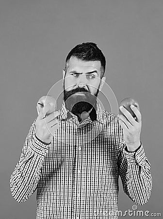 Guy presents homegrown harvest. Farmer with indecisive face Stock Photo