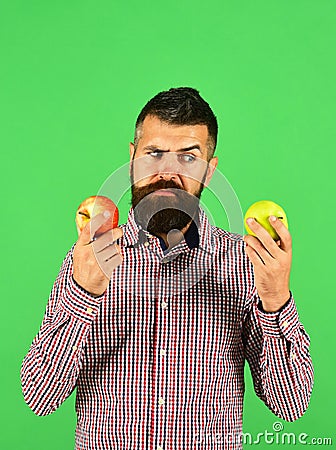 Guy presents homegrown harvest. Farmer with indecisive face Stock Photo