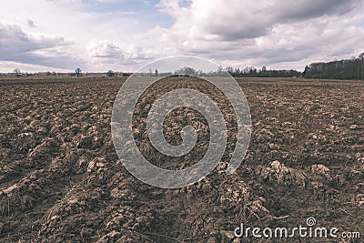 Farmland. Furrows on agricultural land - vintage film look Stock Photo