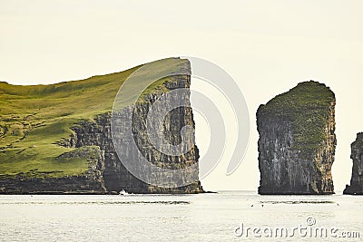 Faroe islands cliffs on atlantic ocean at sunset. Stunning Stock Photo