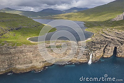 Faroe islands dramatic coastline in Vagar. Leitisvatn lake Stock Photo