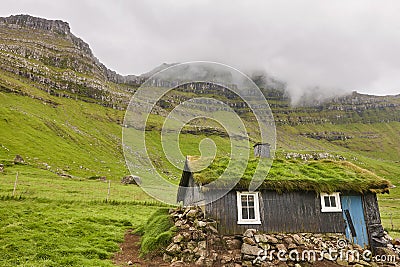 Faroe islands valley and traditional green roof house. Mikladalur, Kalsoy Stock Photo