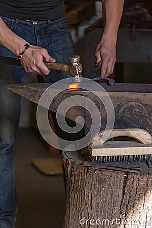 farrier making a traditional horseshoe on a forge Stock Photo