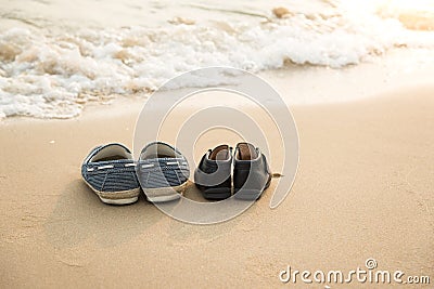 Farther's shoes and son's shoes on thes beac Stock Photo